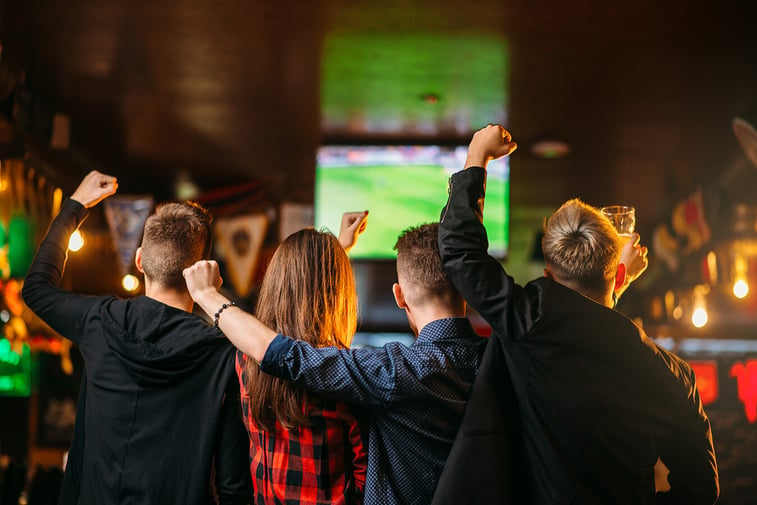 Friends enjoying a football game on television